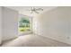 Bright bedroom with a large window and neutral wall color at 7430 Weeping Willow Dr, Sarasota, FL 34241