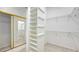 Walk-in closet with built-in shelving and hanging rods at 7430 Weeping Willow Dr, Sarasota, FL 34241