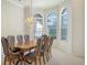 Elegant dining room featuring a chandelier and hardwood table at 7430 Weeping Willow Dr, Sarasota, FL 34241