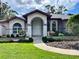 Home's entrance with manicured landscaping at 7430 Weeping Willow Dr, Sarasota, FL 34241