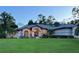 House exterior at dusk, well-lit entrance at 7430 Weeping Willow Dr, Sarasota, FL 34241