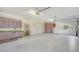 Large garage with storage cabinets, a workbench, and a ceiling fan at 7430 Weeping Willow Dr, Sarasota, FL 34241