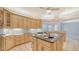 Spacious kitchen featuring granite island and light wood cabinets at 7430 Weeping Willow Dr, Sarasota, FL 34241