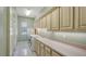 Laundry room with built-in cabinets and countertop at 7430 Weeping Willow Dr, Sarasota, FL 34241