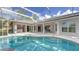 Large kidney-shaped pool with a screened enclosure and adjacent patio at 7430 Weeping Willow Dr, Sarasota, FL 34241