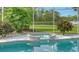 Relaxing spa nestled into the pool area, surrounded by tropical plants at 7430 Weeping Willow Dr, Sarasota, FL 34241