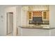 Wet bar with granite countertop and wine rack at 7430 Weeping Willow Dr, Sarasota, FL 34241