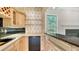 Convenient wet bar with granite countertop and storage at 7430 Weeping Willow Dr, Sarasota, FL 34241