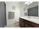 Bathroom features a shower with a gray shower curtain, white vanity, and light fixtures at 9769 Highland Park Pl, Palmetto, FL 34221