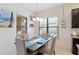 Dining area with a dark wood table, upholstered chairs and a window providing natural light at 9769 Highland Park Pl, Palmetto, FL 34221