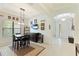 A well-lit dining room features a dark wood table, a hanging light fixture and a unique cabinet with drink cooler at 9769 Highland Park Pl, Palmetto, FL 34221