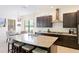 Kitchen and breakfast nook featuring dark wood cabinets, granite countertops, seating at the island and eat in dining at 9769 Highland Park Pl, Palmetto, FL 34221