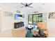 Living room with a large window and sliding glass doors leading to the screened patio, and comfortable seating at 9769 Highland Park Pl, Palmetto, FL 34221