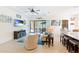 Bright living room with sliding glass doors leading to the screened patio, with TV and neutral furniture at 9769 Highland Park Pl, Palmetto, FL 34221