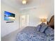 Bright main bedroom features a tray ceiling, ceiling fan, and doorway to the bathroom at 9769 Highland Park Pl, Palmetto, FL 34221