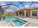 This screened-in pool and spa area with outdoor kitchen create an inviting backyard oasis at 9769 Highland Park Pl, Palmetto, FL 34221