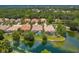 Aerial view showcasing a community of homes near a lake at 7167 Whitemarsh Cir, Lakewood Ranch, FL 34202