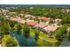 Aerial view showcasing a community of homes near a lake at 7167 Whitemarsh Cir, Lakewood Ranch, FL 34202