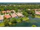 Aerial view showcasing a community of homes near a lake at 7167 Whitemarsh Cir, Lakewood Ranch, FL 34202