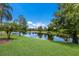 Lush backyard featuring a serene lake and mature trees at 7167 Whitemarsh Cir, Lakewood Ranch, FL 34202