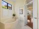 Elegant bathroom featuring a garden tub and access to the bedroom at 7167 Whitemarsh Cir, Lakewood Ranch, FL 34202