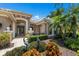 Beautifully landscaped front entrance with brick-paved walkway and decorative sculptures at 7167 Whitemarsh Cir, Lakewood Ranch, FL 34202