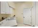 Bright laundry room featuring washer, dryer, and ample cabinetry at 7167 Whitemarsh Cir, Lakewood Ranch, FL 34202