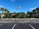 Community building with flag and landscaping at 2687 Golf Course Dr # 219, Sarasota, FL 34234