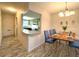 Dining area with a wooden table and blue chairs at 2687 Golf Course Dr # 219, Sarasota, FL 34234