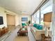 Bright living room with light beige sofas and wood flooring at 2687 Golf Course Dr # 219, Sarasota, FL 34234