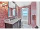 Elegant bathroom with marble vanity and coral wallpaper at 1701 Sandalwood Dr, Sarasota, FL 34231