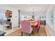 Bright dining room features a wooden table and pink chairs, near kitchen at 1701 Sandalwood Dr, Sarasota, FL 34231