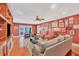 Gathering room with hardwood floors, red walls, and built-in shelving at 1701 Sandalwood Dr, Sarasota, FL 34231