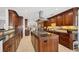 Modern kitchen with island, stainless steel appliances, and wood cabinets at 1701 Sandalwood Dr, Sarasota, FL 34231