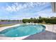 Large kidney shaped pool with spa and patio at 1701 Sandalwood Dr, Sarasota, FL 34231