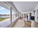 Relaxing screened porch with water views and patio furniture at 1701 Sandalwood Dr, Sarasota, FL 34231