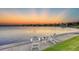 Sunset view over the water with chairs at 1701 Sandalwood Dr, Sarasota, FL 34231