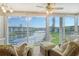 Bright living room with water views and wicker furniture at 4350 Chatham Dr # E307, Longboat Key, FL 34228