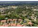 Aerial view of home and community, showcasing surrounding landscape and lake at 7360 Oak Moss Dr # 4, Sarasota, FL 34241