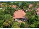 Aerial view showing a charming villa with a tile roof and lush landscaping at 7360 Oak Moss Dr # 4, Sarasota, FL 34241