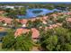 Aerial view of community with lake and numerous single Gathering homes at 7360 Oak Moss Dr # 4, Sarasota, FL 34241