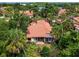 Backyard view of single Gathering home with tile roof and lush landscaping at 7360 Oak Moss Dr # 4, Sarasota, FL 34241