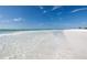 Relaxing beach view with clear water lapping on a white sand shore at 7360 Oak Moss Dr # 4, Sarasota, FL 34241