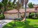 Single-Gathering home with tile roof, two-car garage, and manicured lawn at 7360 Oak Moss Dr # 4, Sarasota, FL 34241