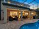 Night view of a luxurious pool and patio area at 7758 Us Open Loop, Lakewood Ranch, FL 34202