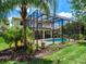 Inviting pool and spa area with a screened enclosure at 7758 Us Open Loop, Lakewood Ranch, FL 34202