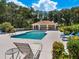 Community pool with a shaded seating area at 7758 Us Open Loop, Lakewood Ranch, FL 34202