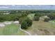 Aerial view of a golf course with fairways, sand traps, and large oak trees at 2120 Golf Manor Blvd, Valrico, FL 33594