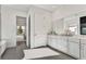 Well-lit bathroom with double vanity, white cabinets, and tiled floors at 2605 Waterfront Cir, Sarasota, FL 34240