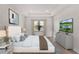 Serene bedroom with tray ceiling, neutral decor, and a view of the water at 2605 Waterfront Cir, Sarasota, FL 34240